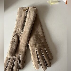 Beautiful new Michael Kors suede gloves with zippers. Measuring 13”